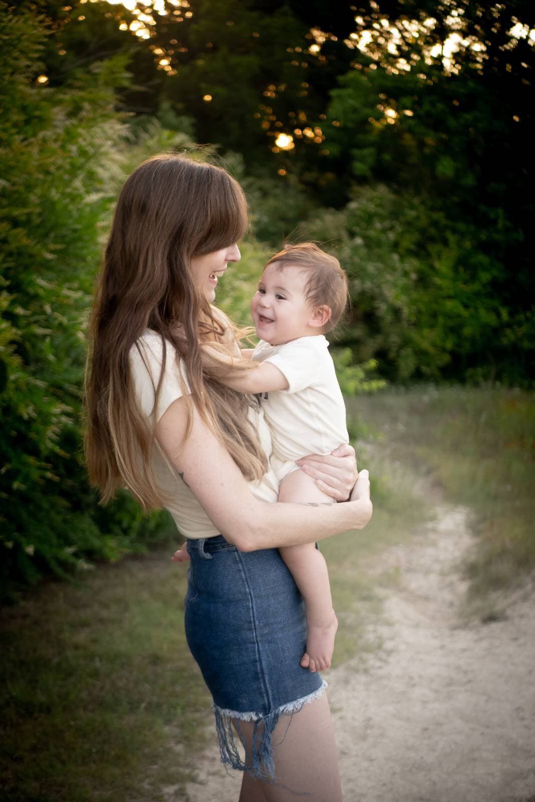 Megan laughing with her daughter on a summer path